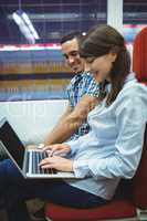 Executives using laptop travelling in train