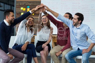 Team of businesspeople giving high five