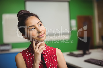 Thoughtful schoolgirl in classroom