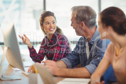 Team of graphic designers working together at desk