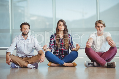 Business executives practicing yoga