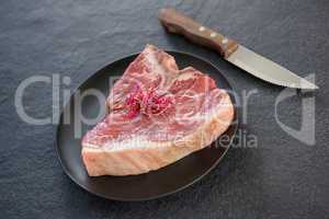 Sirloin chops garnished with shredded cabbage and knife