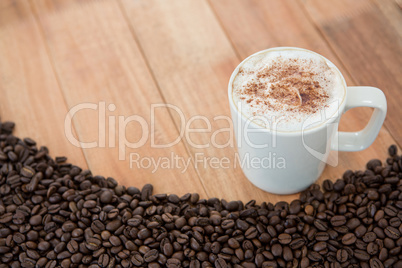 Coffee mug with roasted coffee beans