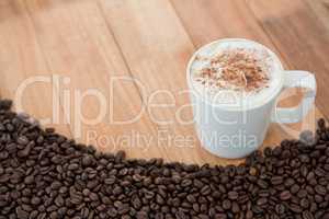 Coffee mug with roasted coffee beans