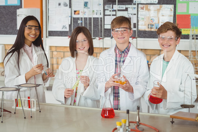 Portrait of school kids doing a chemical experiment in laboratory