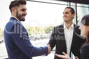 Business executives shaking hands on platform