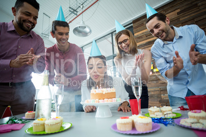Businesspeople celebrating their colleagues birthday