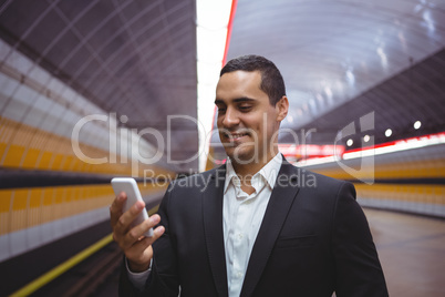 Smiling executive using mobile phone