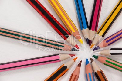 Close-up of colored pencils arranged in a circle