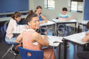 Schoolgirl sitting at desk in classroom