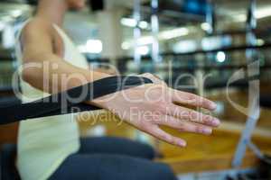 Woman practicing stretching exercise on reformer