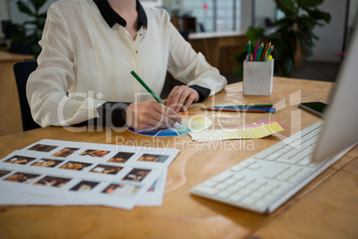 Female graphic designer working at desk