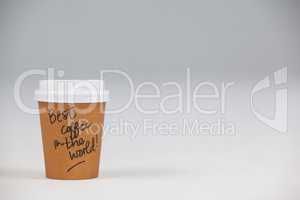 Disposable coffee cup with written text on white background