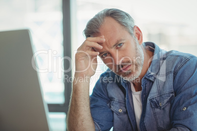 Worried male executive sitting in office