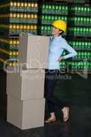 Tensed female worker standing with back pain