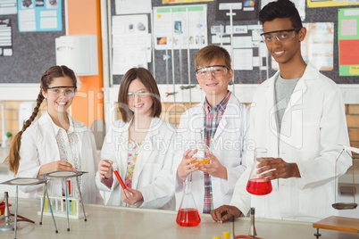 Portrait of school kids doing a chemical experiment in laboratory