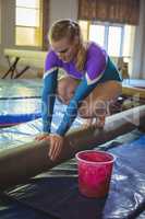 Female gymnast practicing gymnastics on the balance beam