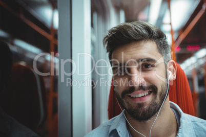 Executive listening music while travelling in train