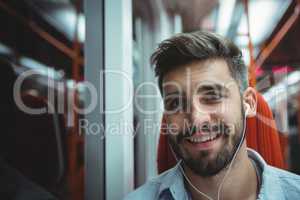 Executive listening music while travelling in train