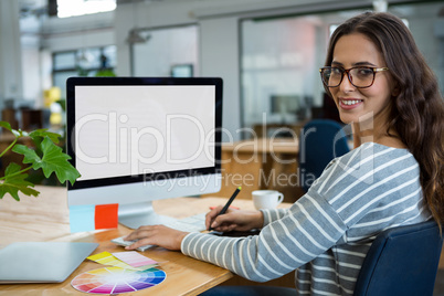 Female graphic designer working at desk