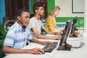 Students studying in computer classroom