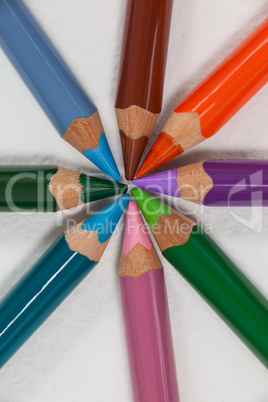 Close-up of colored pencils arranged in a circle