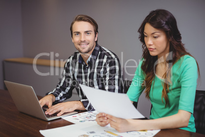 Male and graphic designers working together in conference room