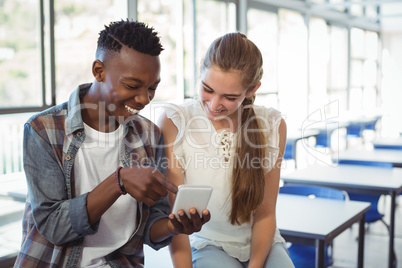 Schoolkids using mobile phone in classroom