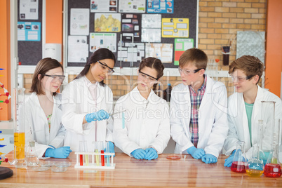 Attentive school kids doing a chemical experiment in laboratory