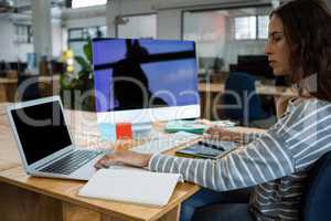 Female graphic designer working at desk