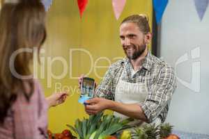 Woman making a payment by using NFC technology