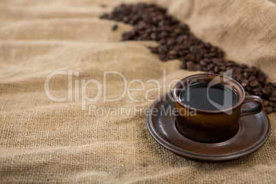 Black coffee served and coffee beans on sack
