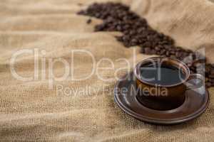 Black coffee served and coffee beans on sack