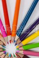 Close-up of colored pencils arranged in a circle