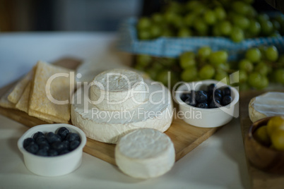 Variety of cheese and blue berry on counter
