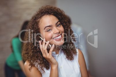 Female executive using mobile phone in office