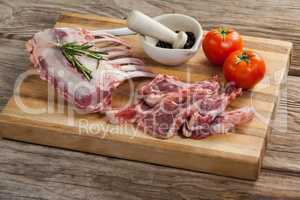 Rib rack, rib chops and ingredients on wooden board