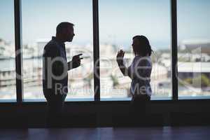 Couple arguing near the window