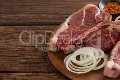 Blade chop, onions and spices on wooden round tray