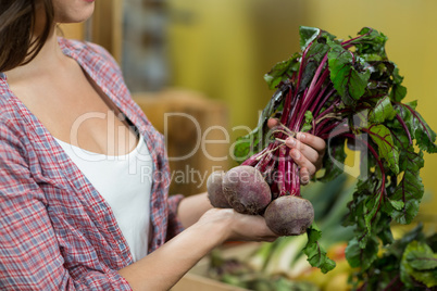 Woman choosing vegetables in grocery store