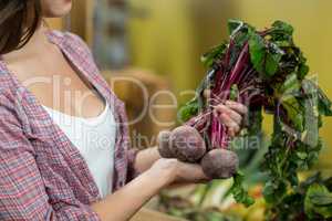 Woman choosing vegetables in grocery store