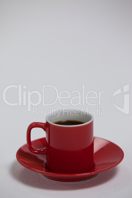 Black coffee served in red cup