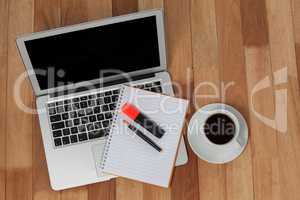 Cup of coffee with laptop, organizer, maker and pen