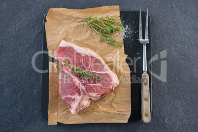 Sirloin chop and fork on slate plate