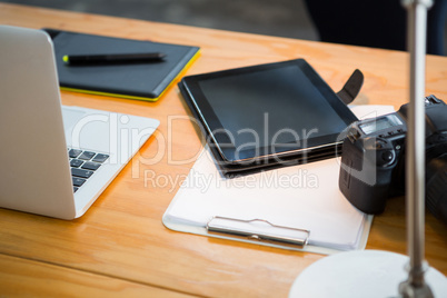 Laptop, digital tablet and digital camera on desk