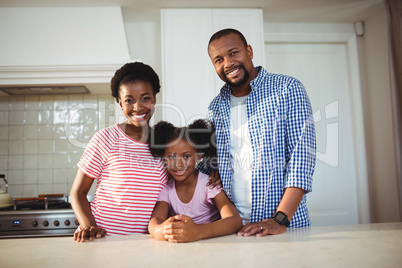 Portrait of parents and daughter in kitchen