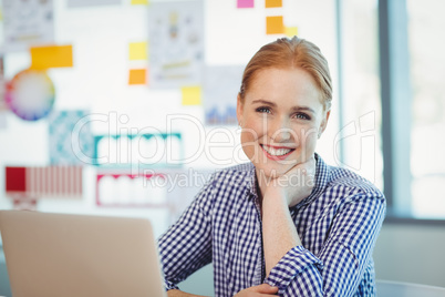 Portrait of female executive sitting in office