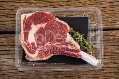 Rib chop and herbs in plastic box