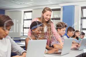 Students using laptop in classroom