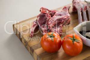 Rib rack, rib chop and ingredients on wooden board